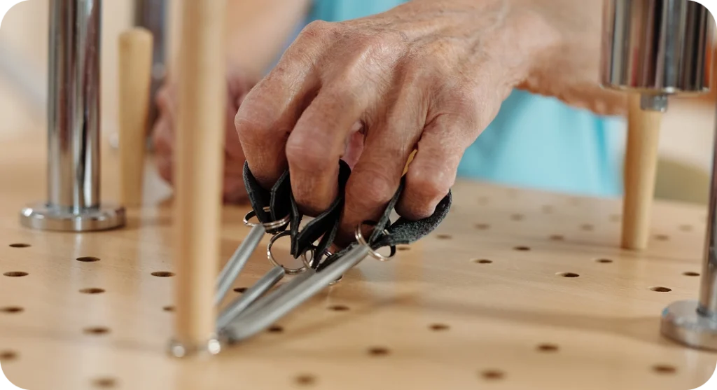 Hands using tools on a wooden surface