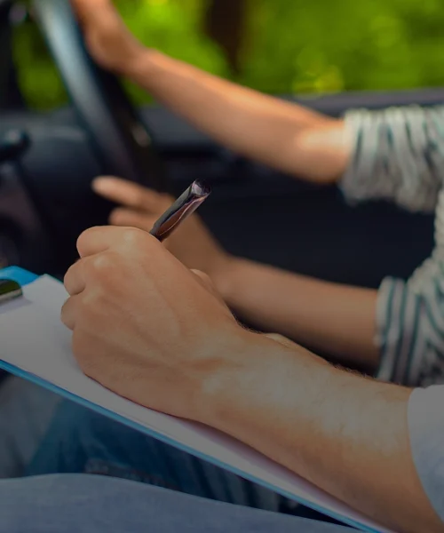 erson writing notes on a clipboard close-up