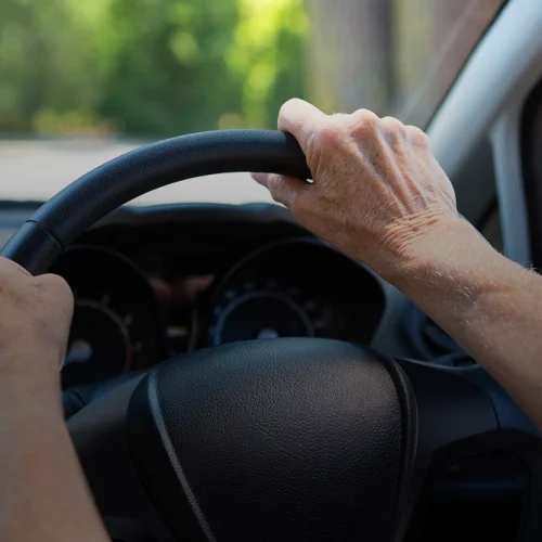 Hand on steering wheel while driving