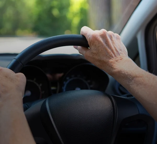 Hand on steering wheel while driving